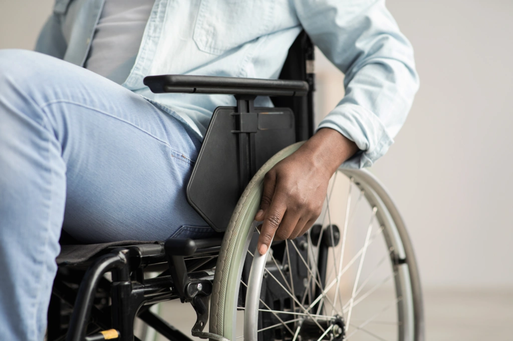 Person using a wheelchair during paralysis rehabilitation, highlighting mobility support and neurological recovery care.